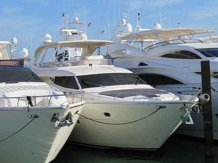 several white boats in a harbor aboard SAR Yacht for Sale