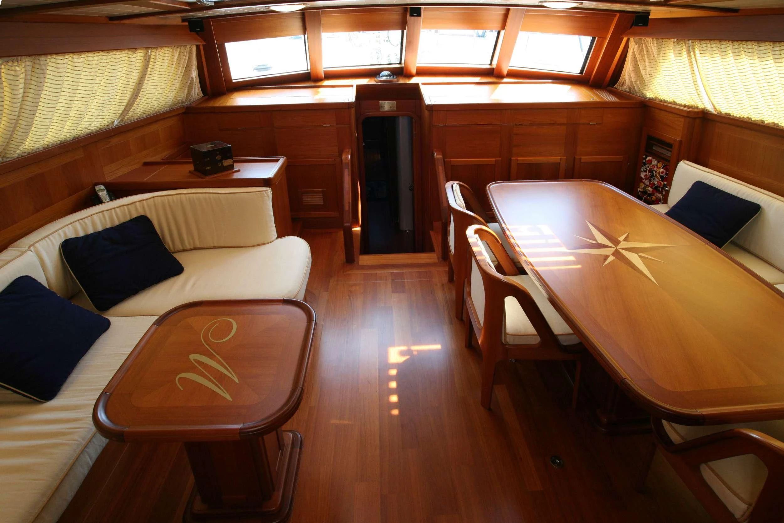 a room with a bed and a table aboard MARELLA Yacht for Sale