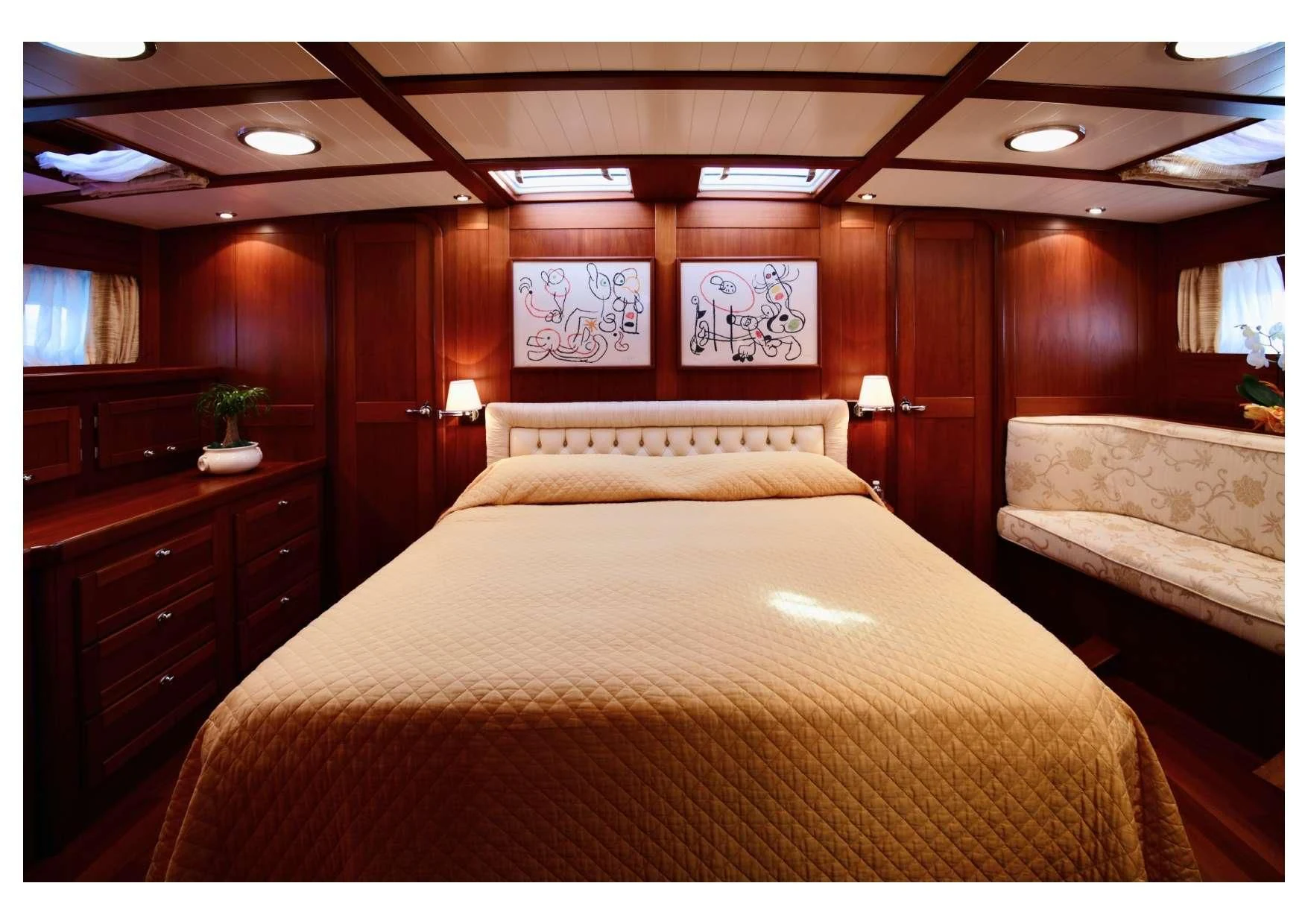 a bed with a wooden headboard aboard MARELLA Yacht for Sale