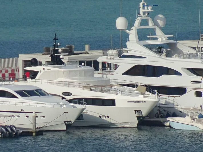 a group of white yachts aboard NAHAR Yacht for Sale