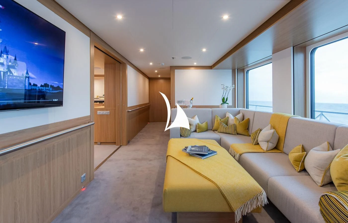 a room with a couch and a tv aboard GAME CHANGER Yacht for Sale