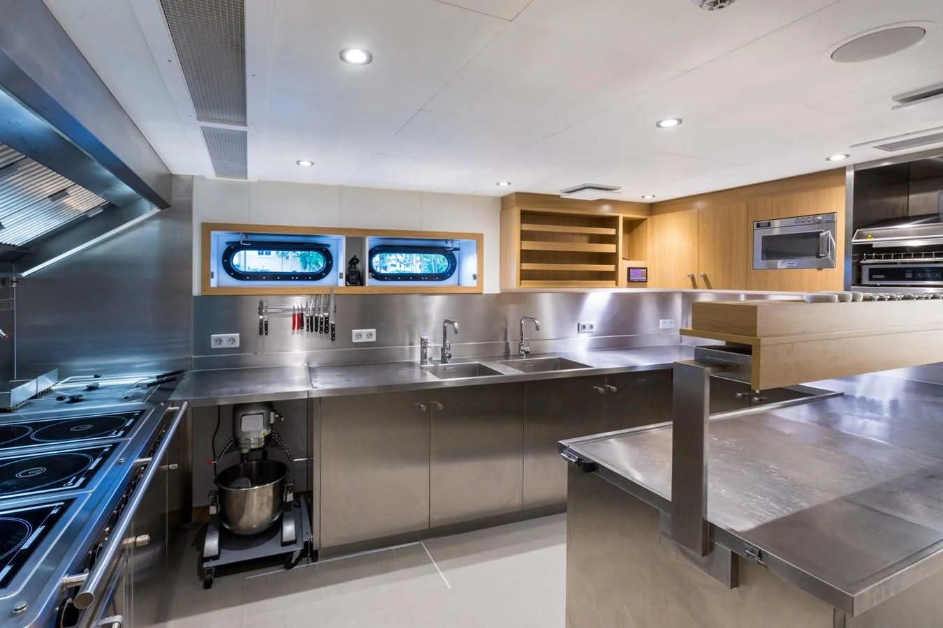 a kitchen with a countertop sink and a tv aboard GAME CHANGER Yacht for Sale
