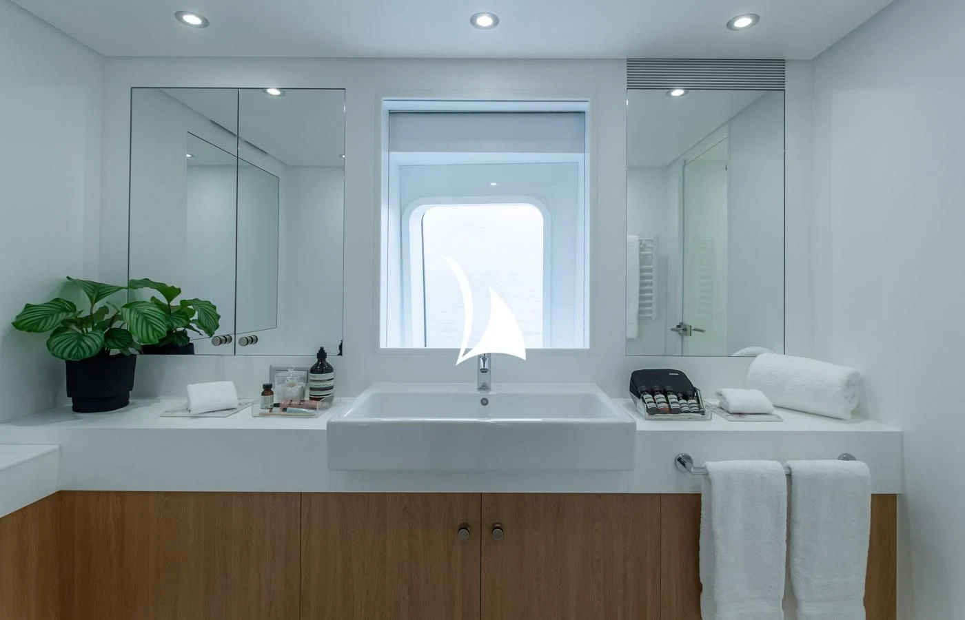 a bathroom with a sink and a mirror aboard GAME CHANGER Yacht for Sale