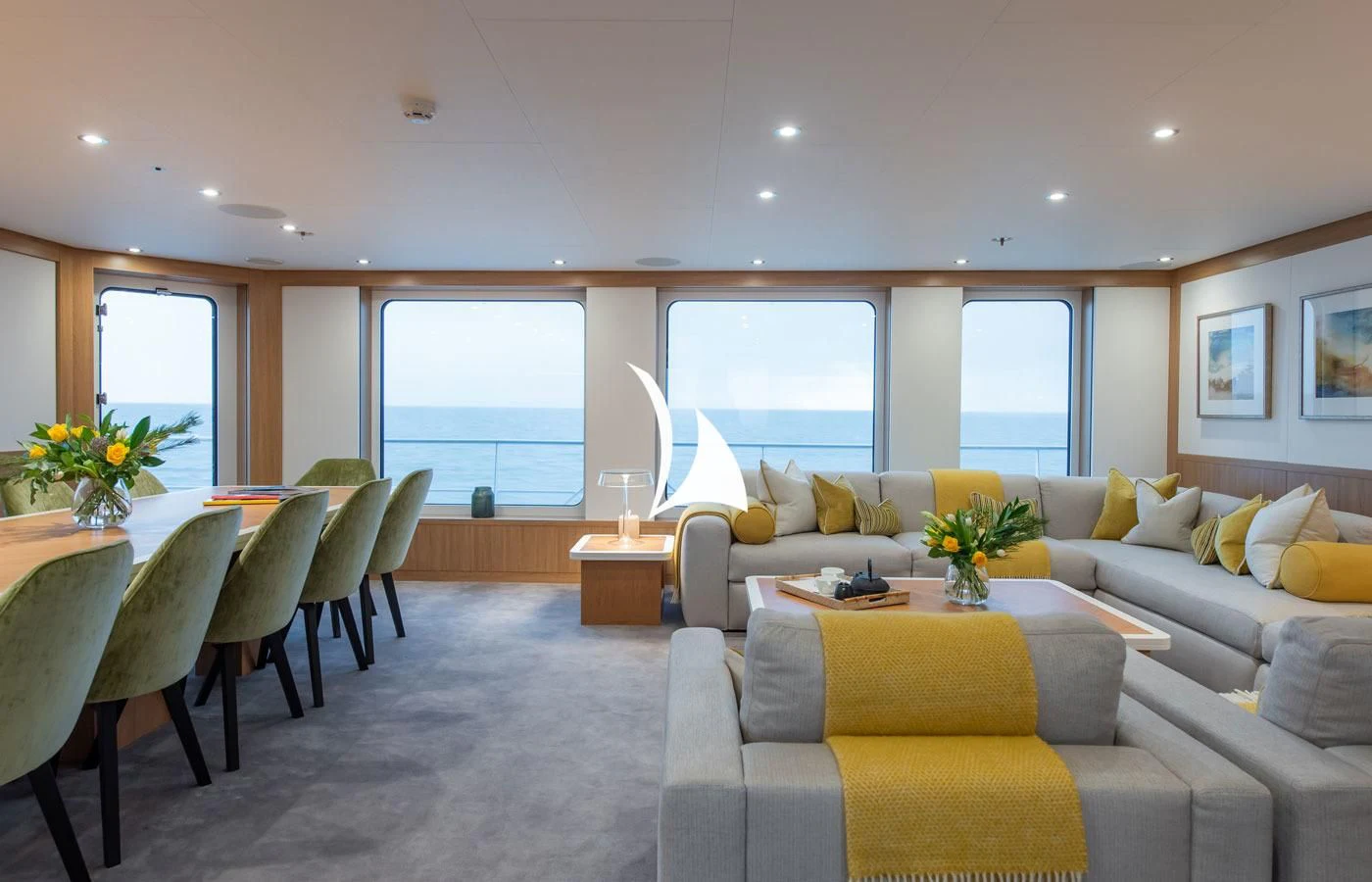 a living room with a couch and a table aboard GAME CHANGER Yacht for Sale