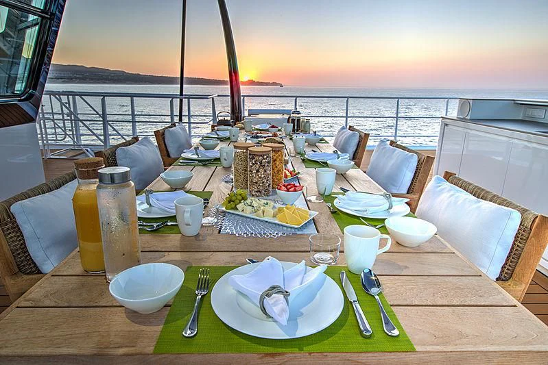 a table with plates and food on it aboard GAME CHANGER Yacht for Sale