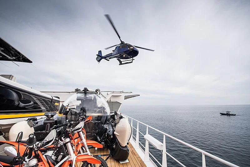 a helicopter flying over a ship aboard GAME CHANGER Yacht for Sale