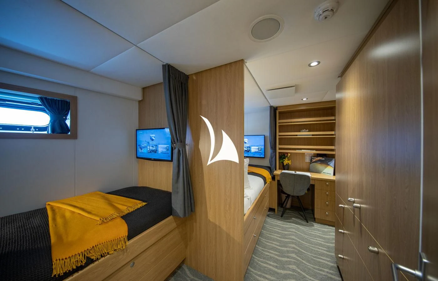 a bedroom with a bed and a tv aboard GAME CHANGER Yacht for Sale