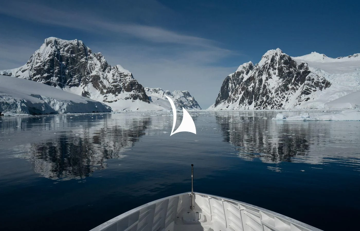 a boat on a lake with mountains in the background aboard GAME CHANGER Yacht for Sale