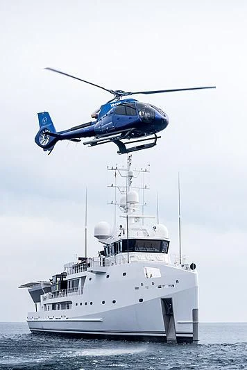 a helicopter flying over a boat aboard GAME CHANGER Yacht for Sale