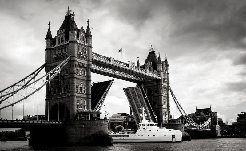 a boat in front of Tower Bridge aboard GAME CHANGER Yacht for Sale