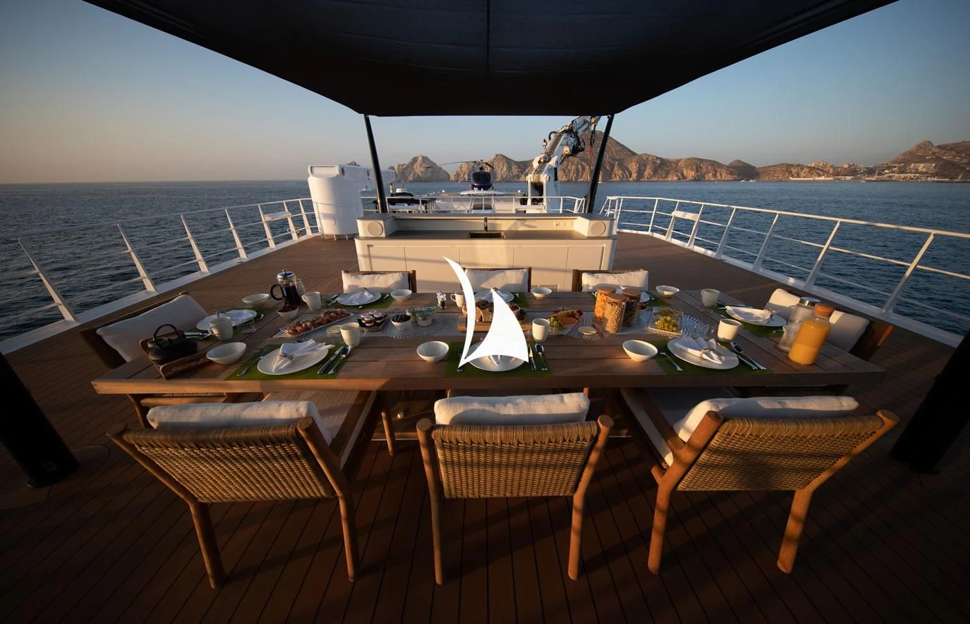 a table with plates and food on it aboard GAME CHANGER Yacht for Sale
