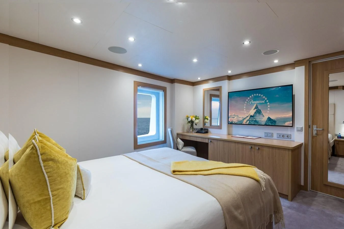 a bedroom with a tv on the wall aboard GAME CHANGER Yacht for Sale