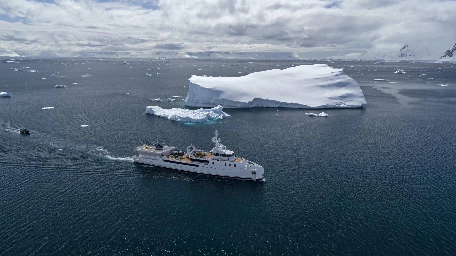 a ship in the water with icebergs in the background aboard GAME CHANGER Yacht for Sale