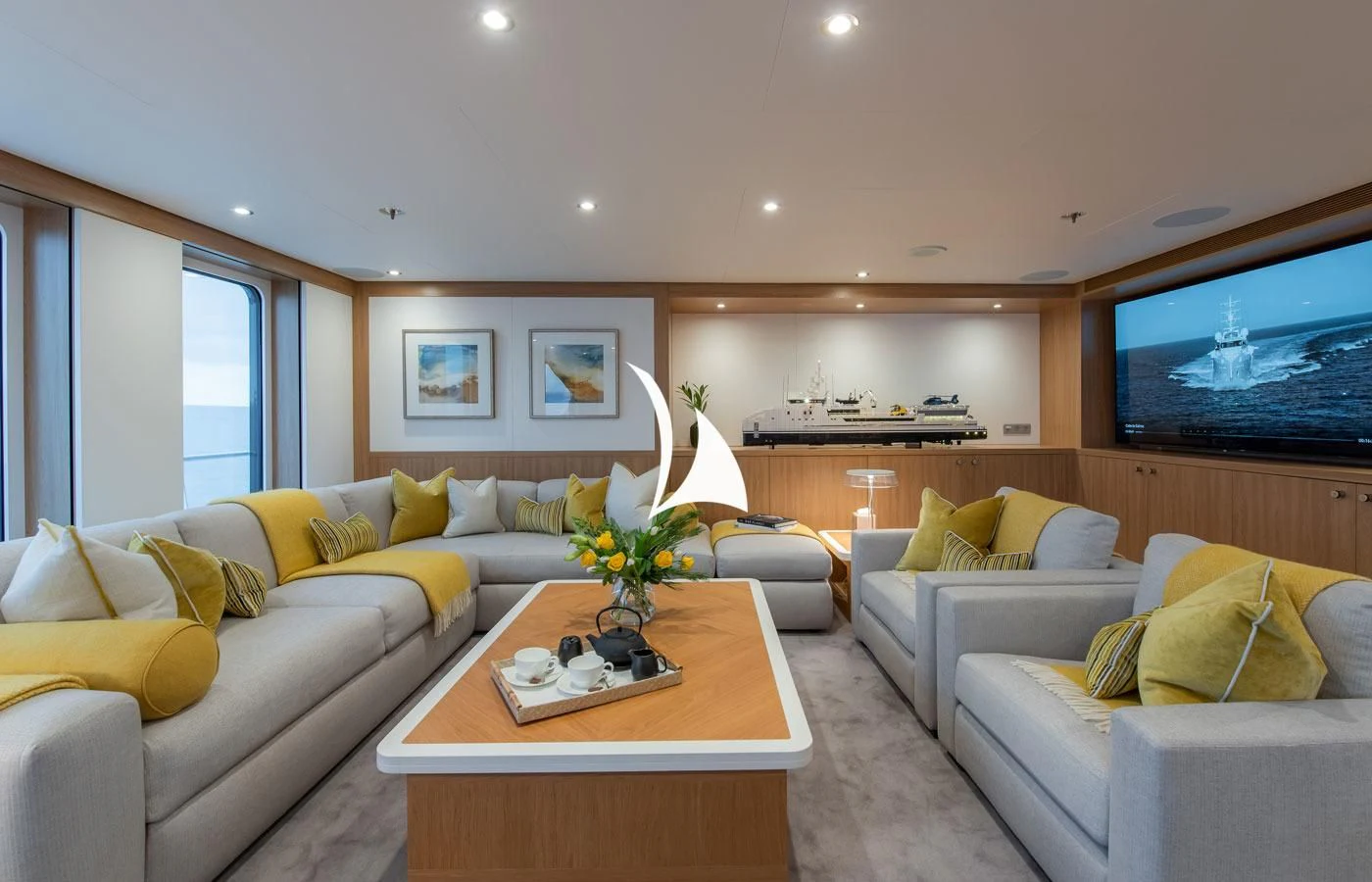 a living room with a couch and a television aboard GAME CHANGER Yacht for Sale