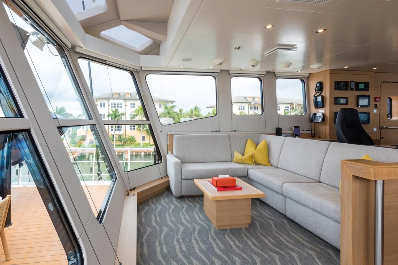 a living room with a couch and a table aboard GAME CHANGER Yacht for Sale