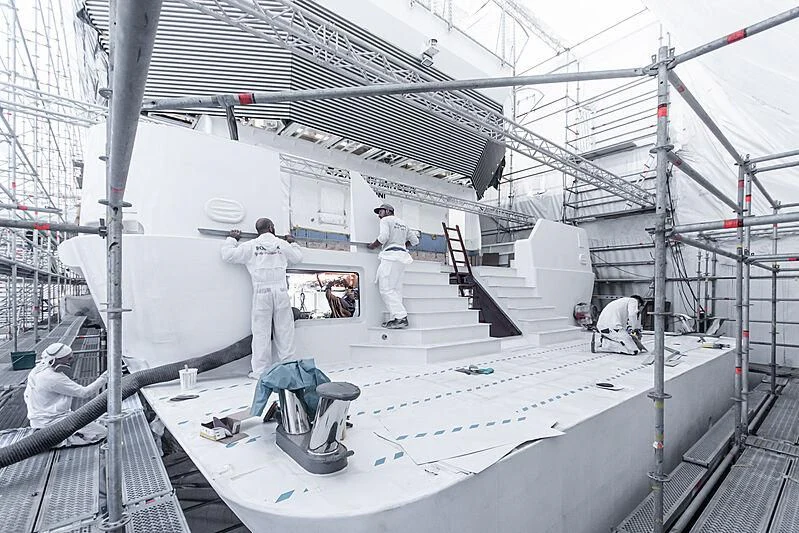 a group of men working on a white machine aboard GAME CHANGER Yacht for Sale