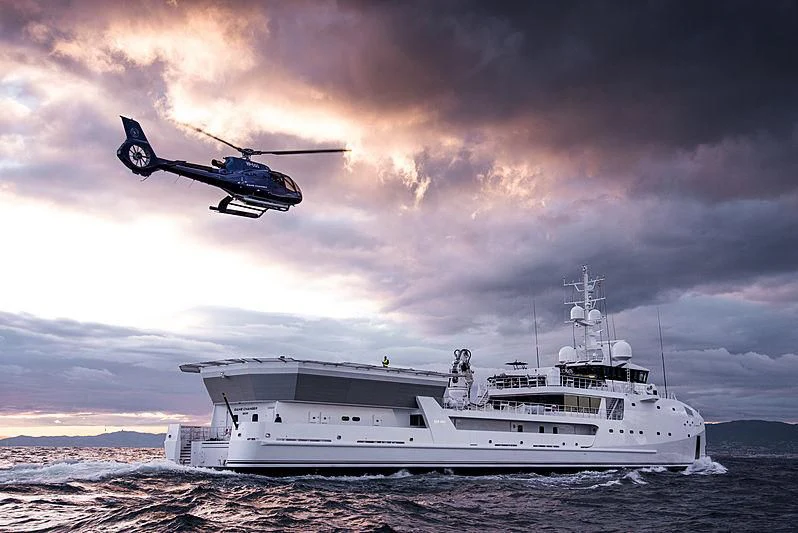 a helicopter flying over a boat aboard GAME CHANGER Yacht for Sale