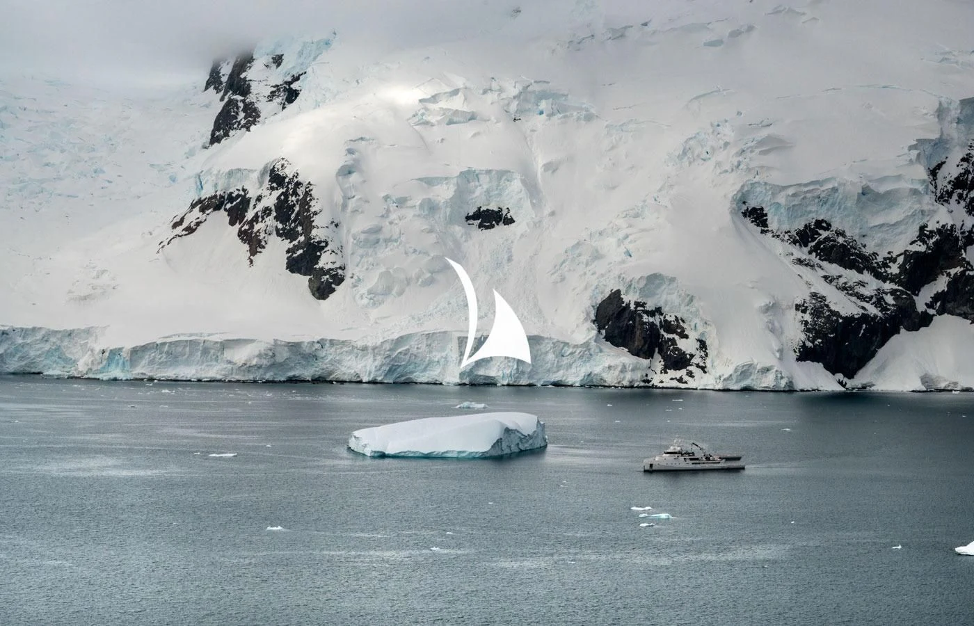 a large iceberg in the ocean aboard GAME CHANGER Yacht for Sale