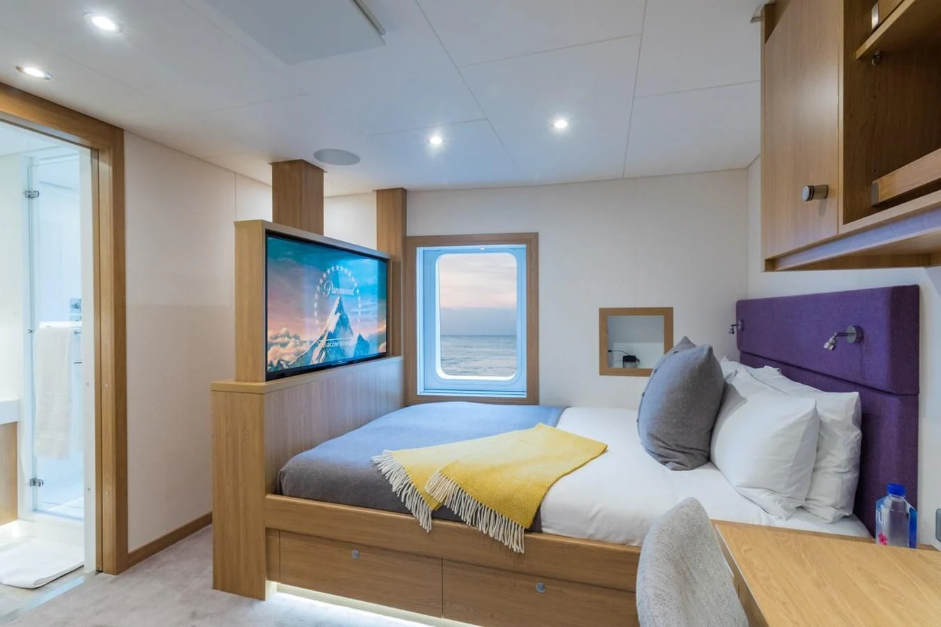 a large living room with a large television aboard GAME CHANGER Yacht for Sale