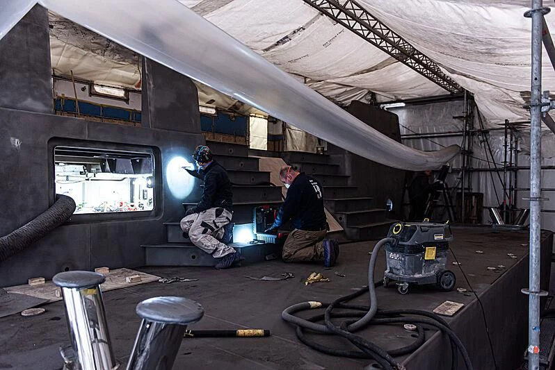 a few men working on a project aboard GAME CHANGER Yacht for Sale