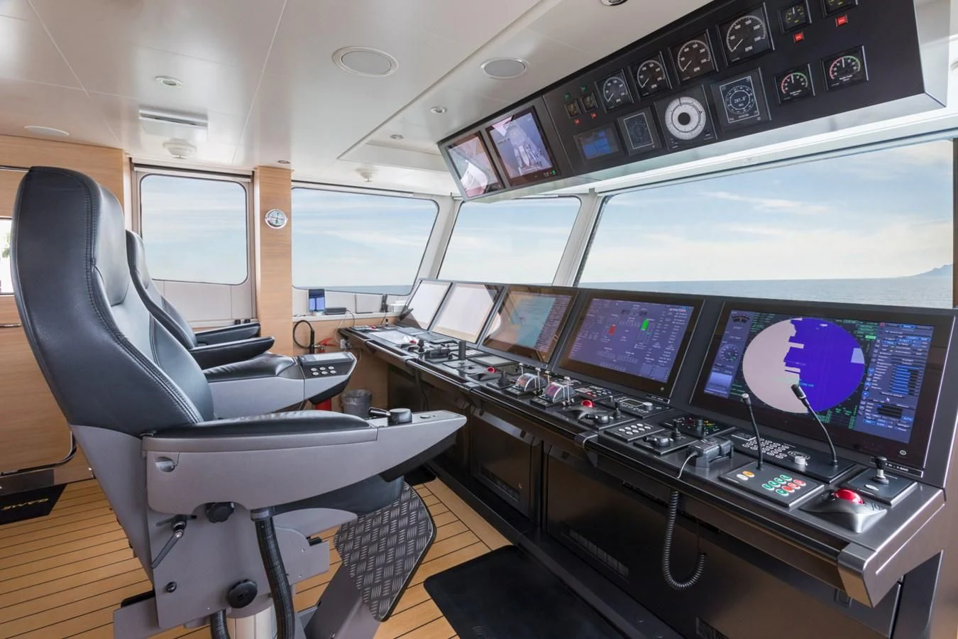 a control room with several monitors aboard GAME CHANGER Yacht for Sale