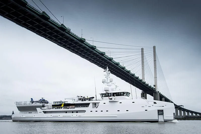 a large white boat under a bridge aboard GAME CHANGER Yacht for Sale