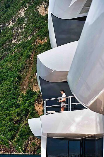 a person standing on a balcony aboard ARTEFACT Yacht for Sale