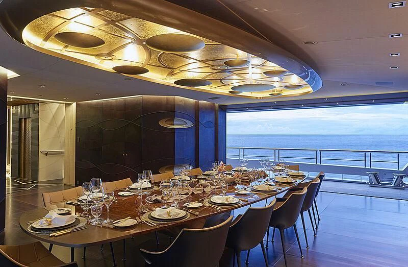 a dining room with a large balcony aboard ARTEFACT Yacht for Sale
