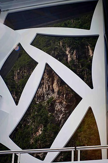 a view of a forest from a window aboard ARTEFACT Yacht for Sale