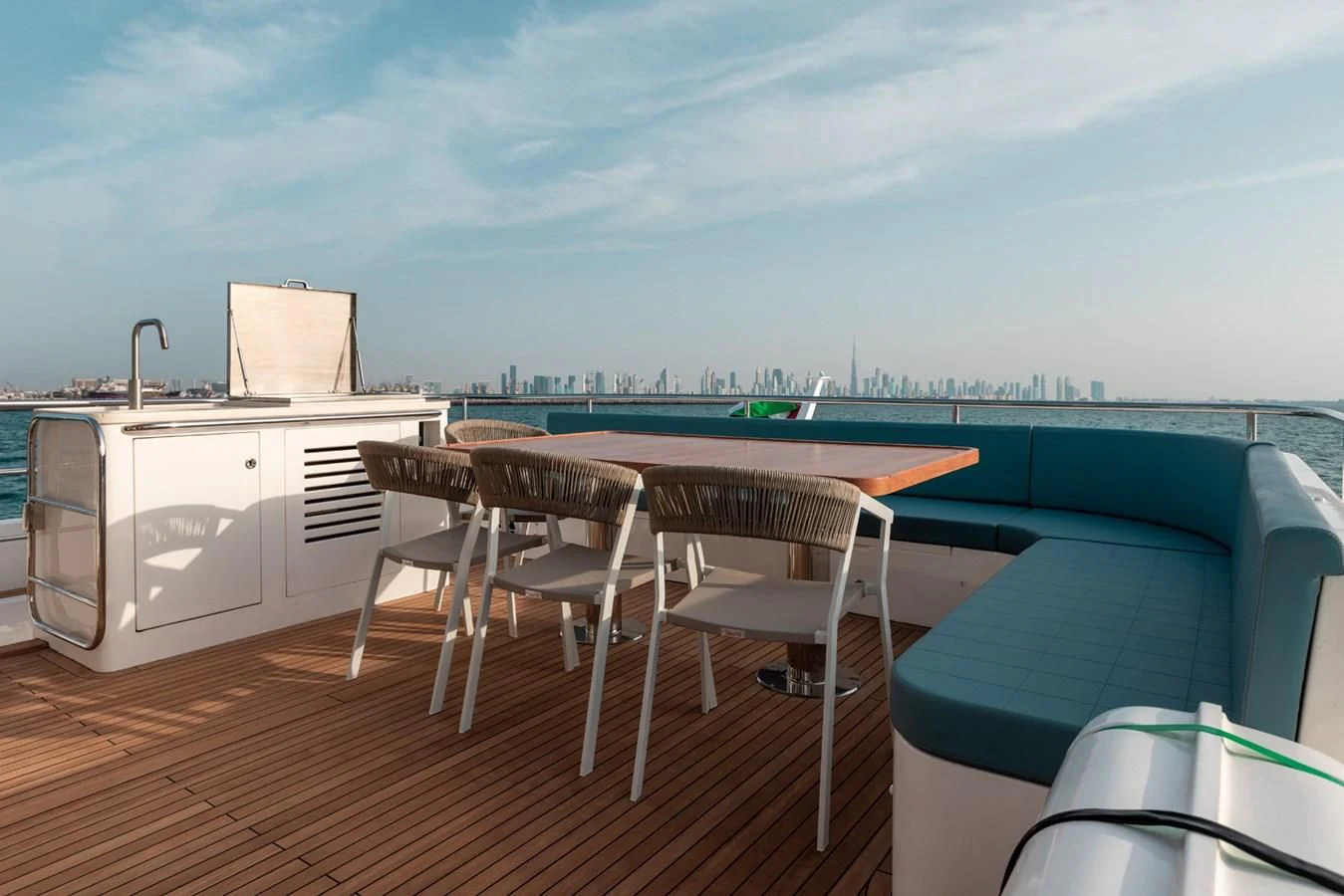 a deck with a table and chairs on it aboard RODINIA 2 Yacht for Sale