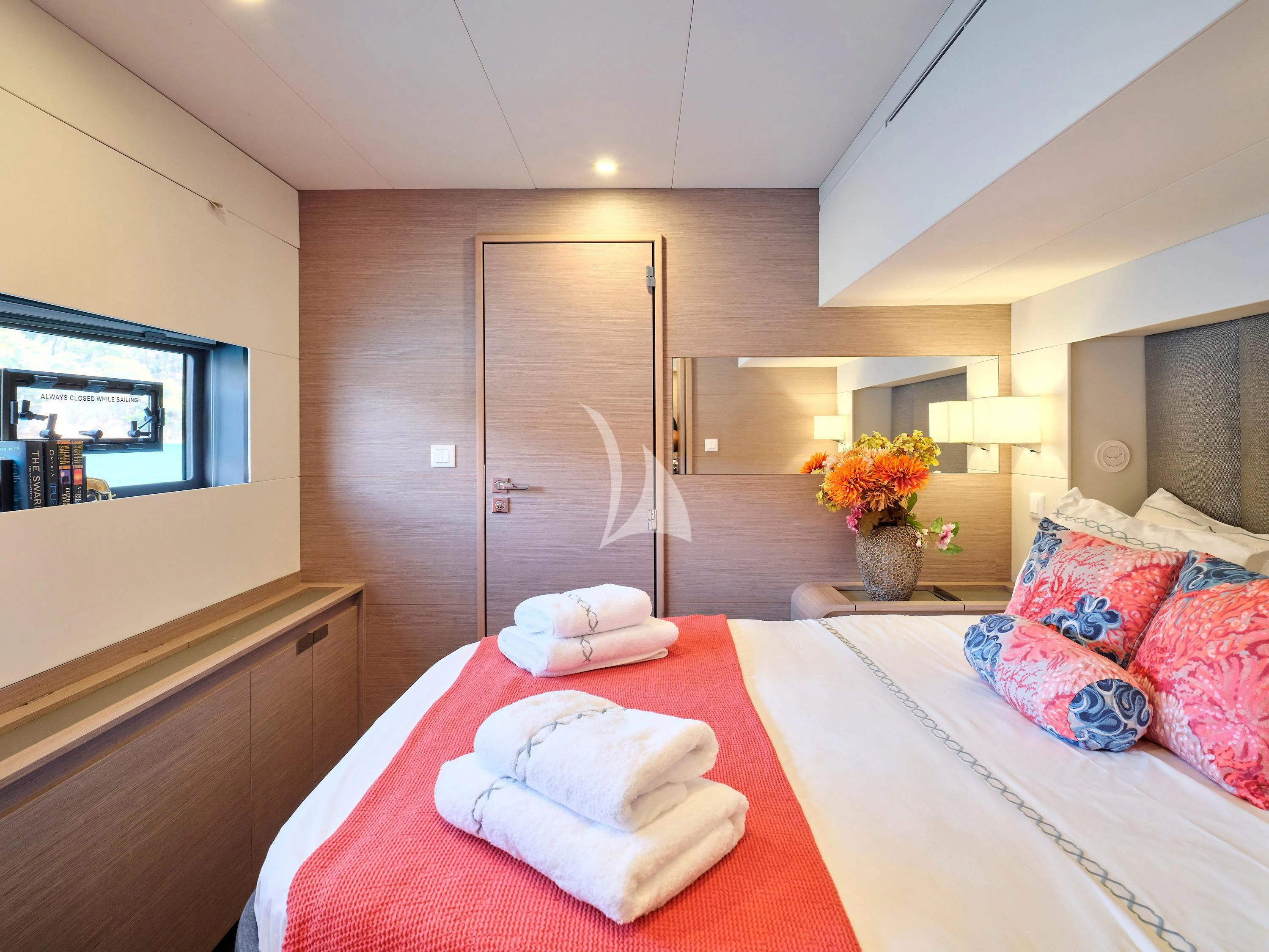 a bedroom with a bed and a television aboard KIMATA Yacht for Charter