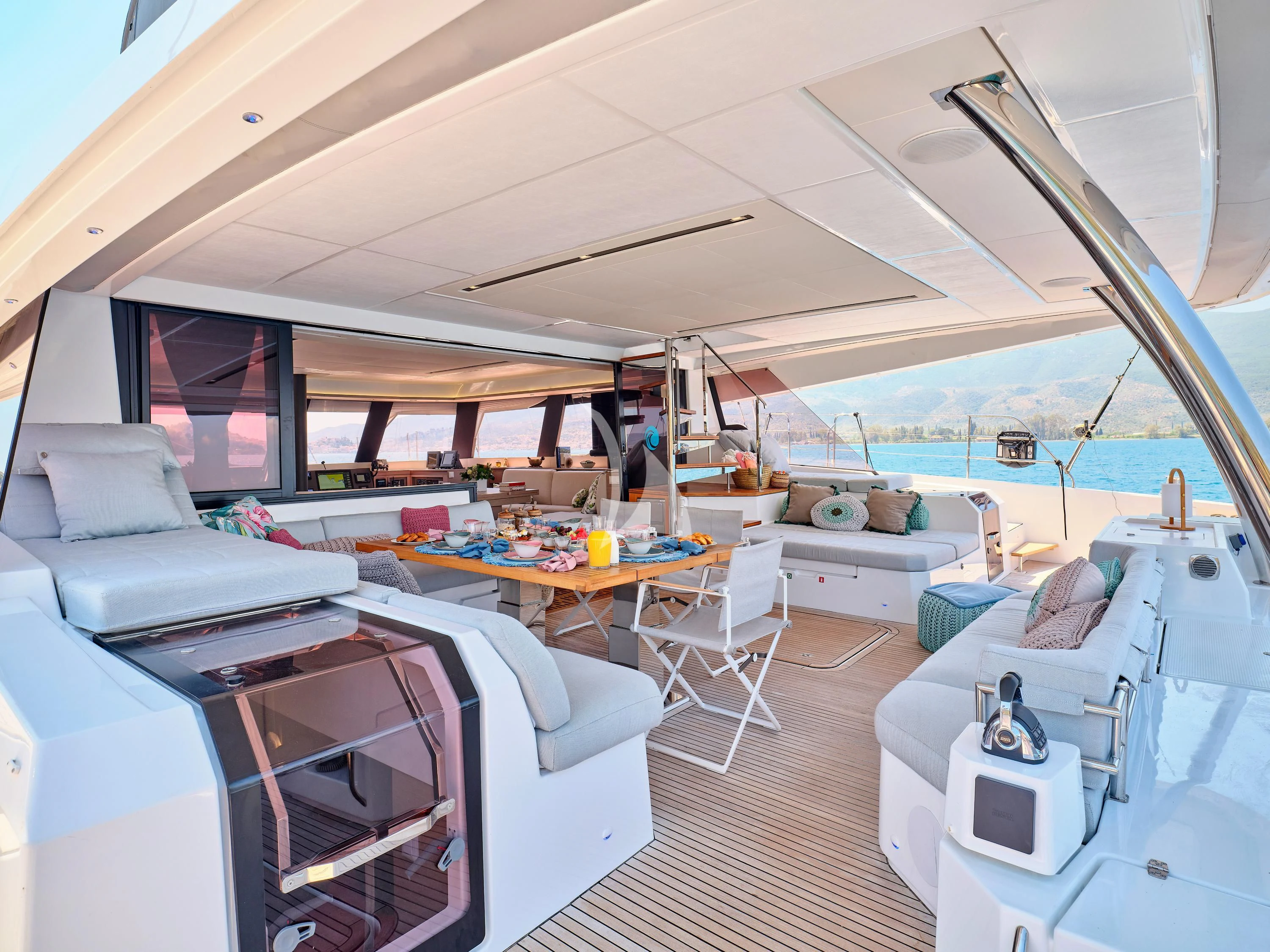 a room with a large window and a table with chairs and a large window aboard KIMATA Yacht for Charter