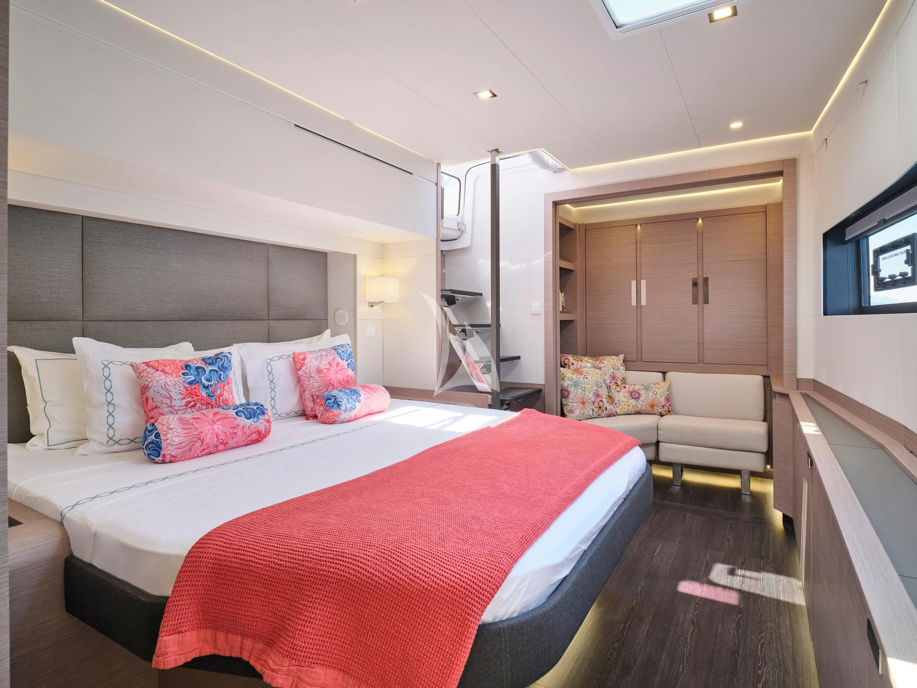 a bedroom with a bed and a couch aboard KIMATA Yacht for Charter