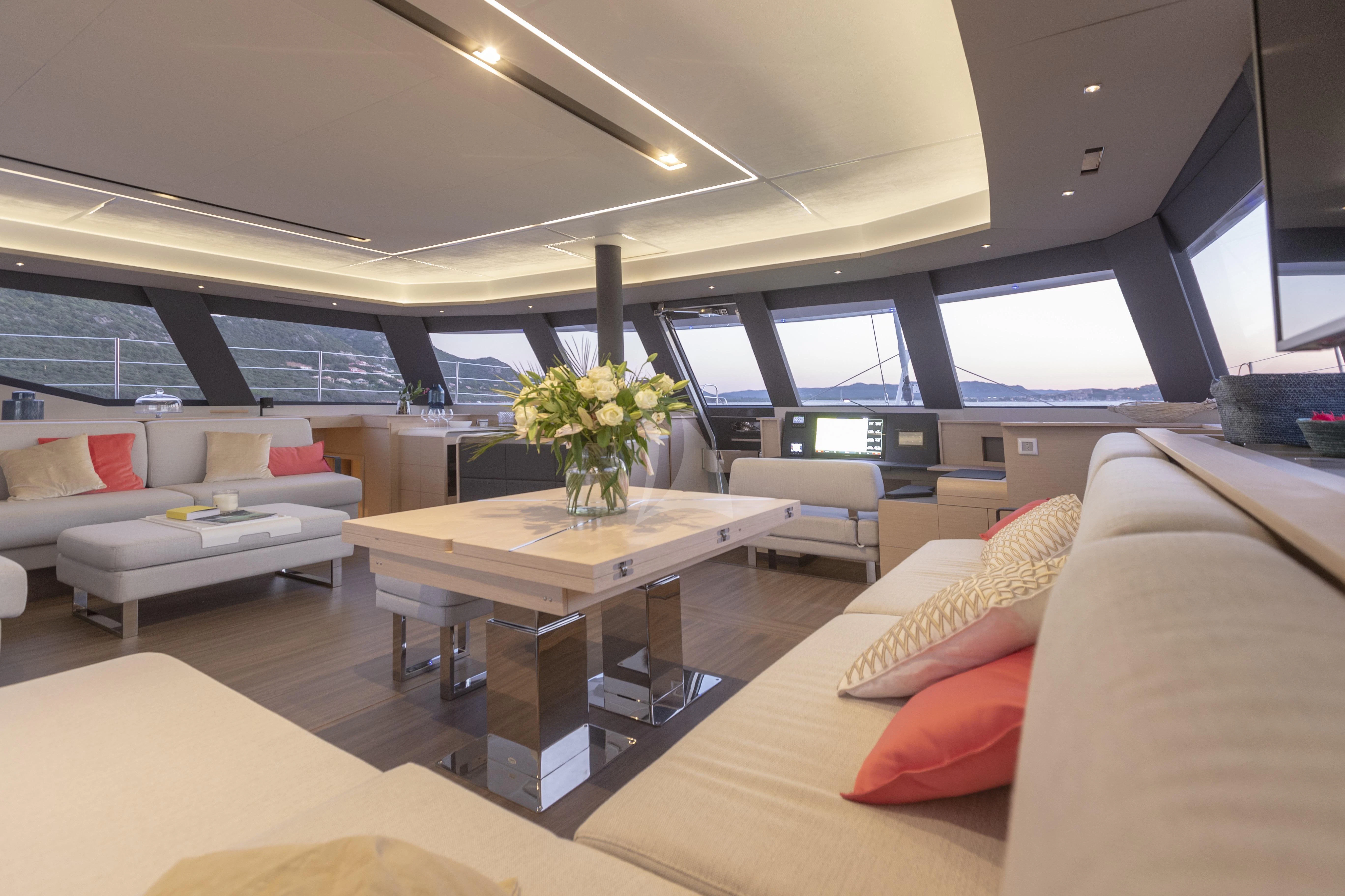 a living room with a large window aboard KIMATA Yacht for Charter