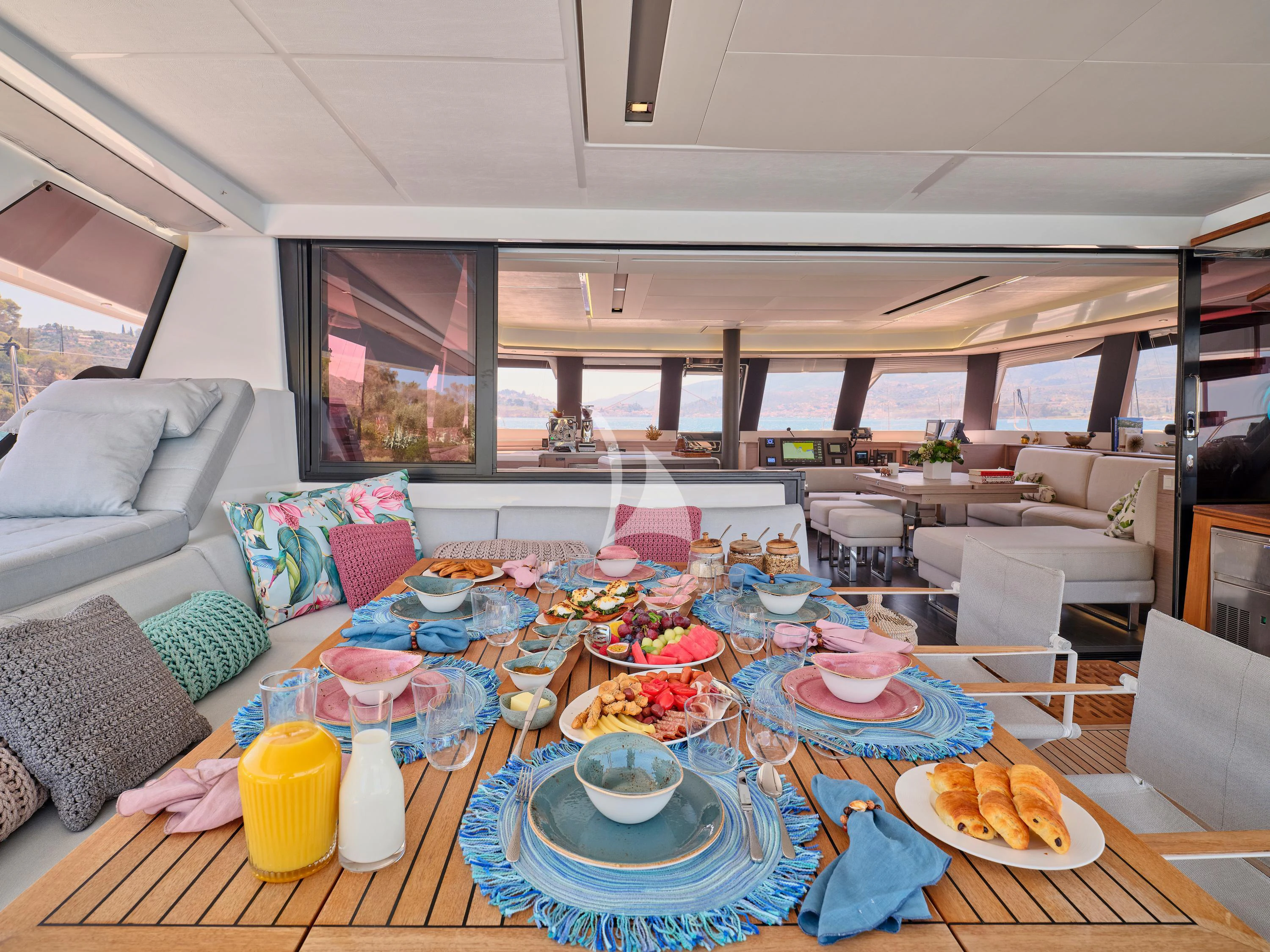 a table with plates and food on it aboard KIMATA Yacht for Charter