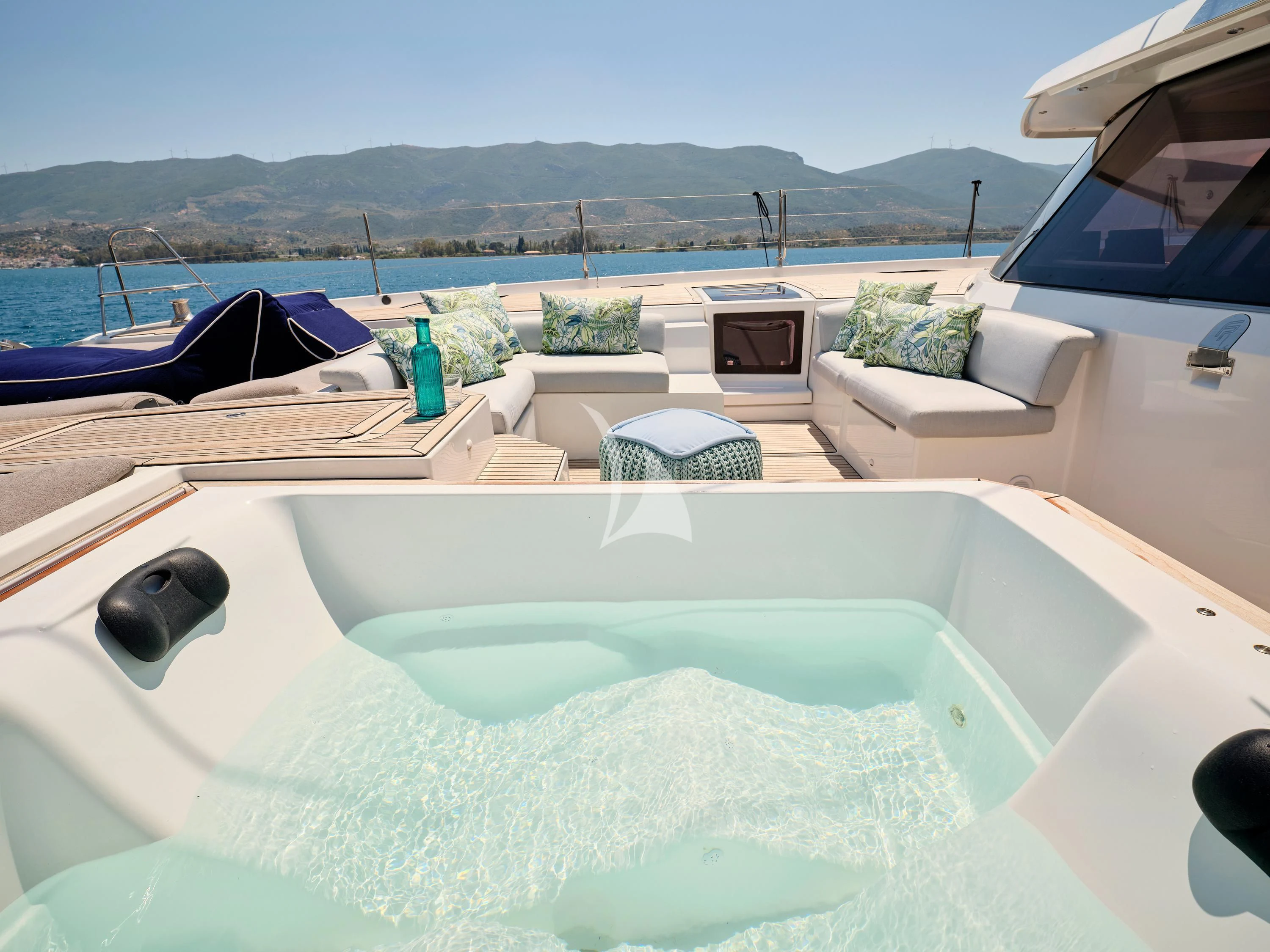 a pool with a couch and a pool in the background aboard KIMATA Yacht for Charter
