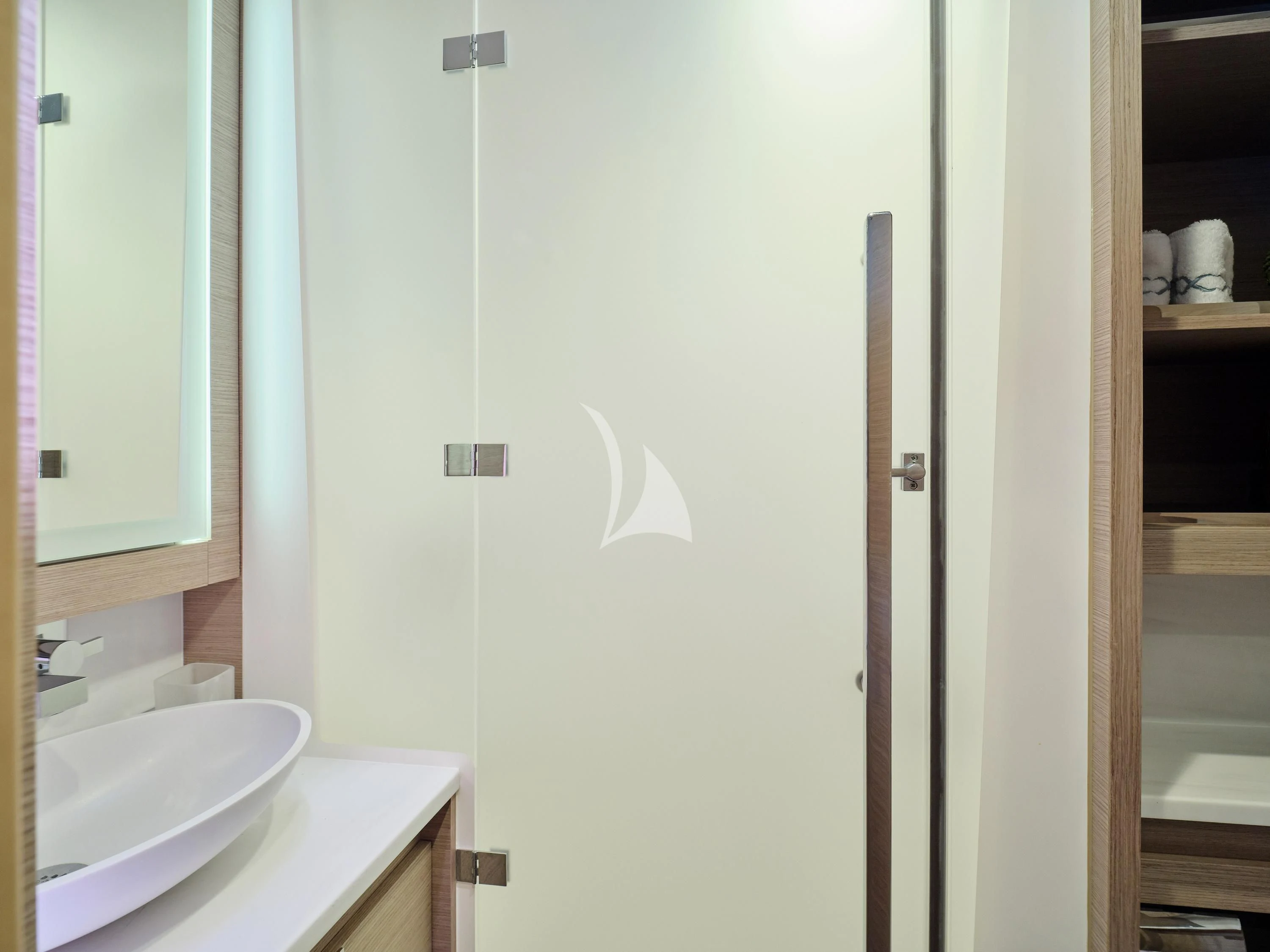 a bathroom with a sink and a door aboard KIMATA Yacht for Charter