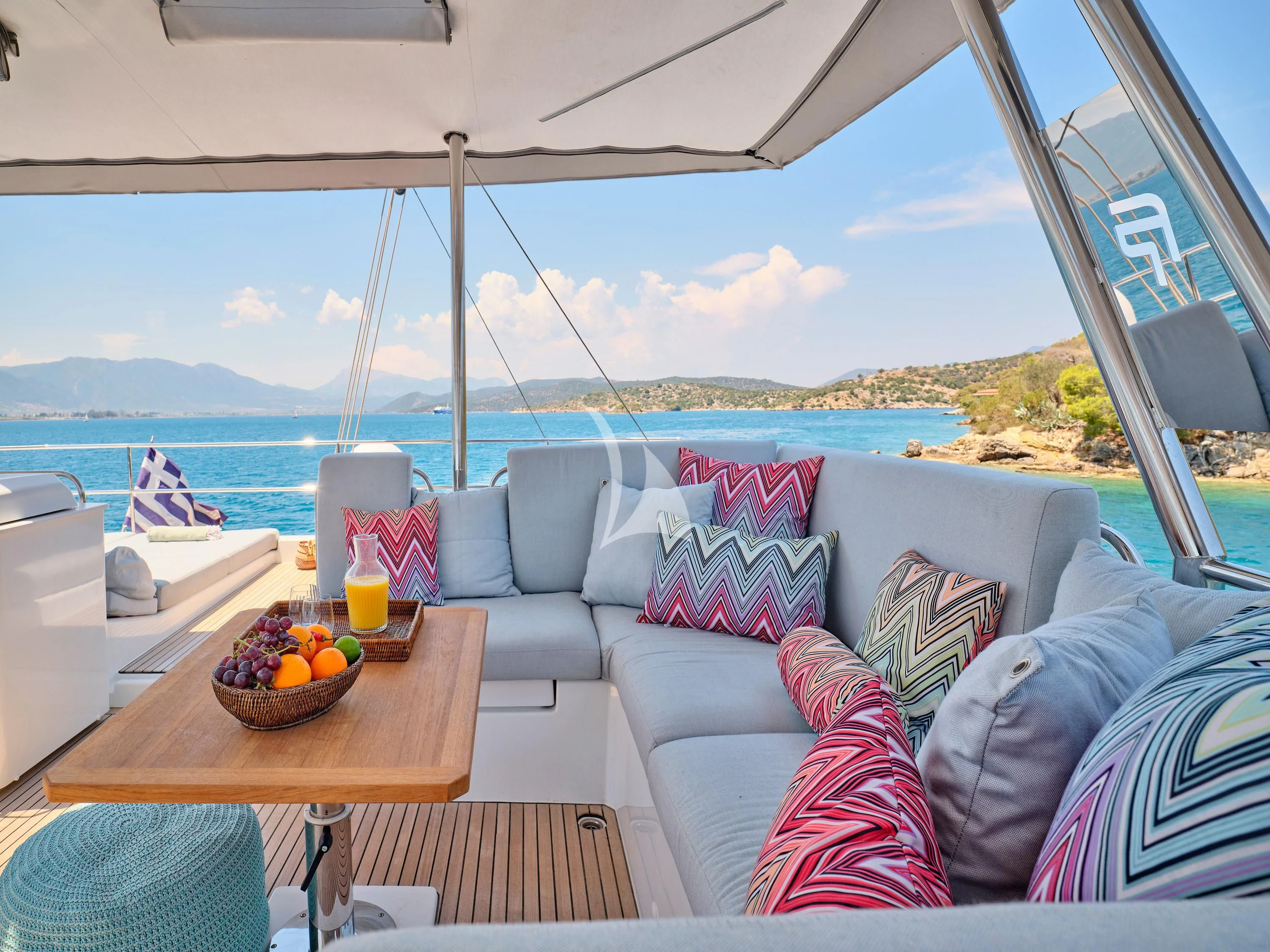 a table with a bowl of fruit on it aboard KIMATA Yacht for Charter