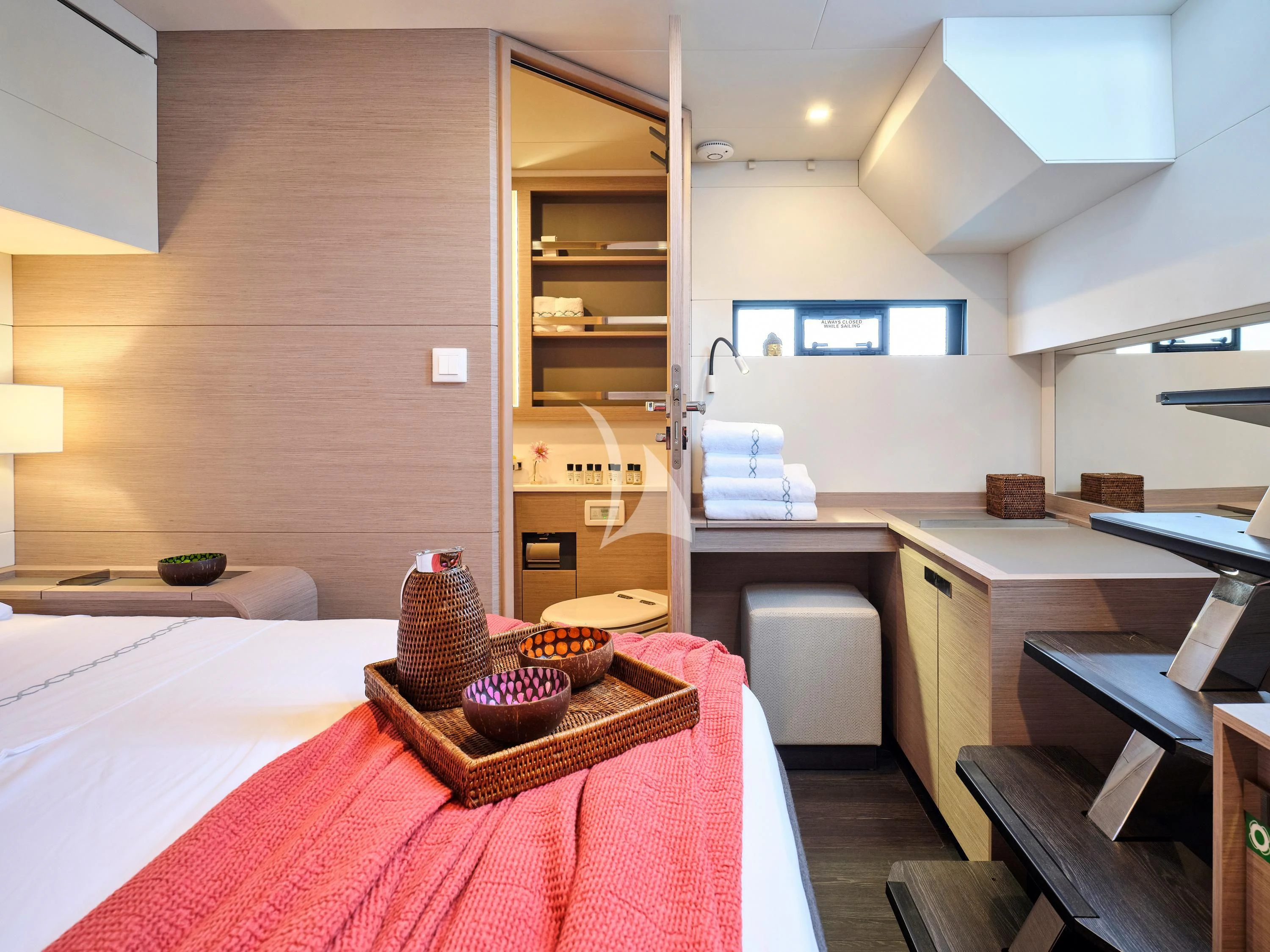 a room with a bed and a desk aboard KIMATA Yacht for Charter