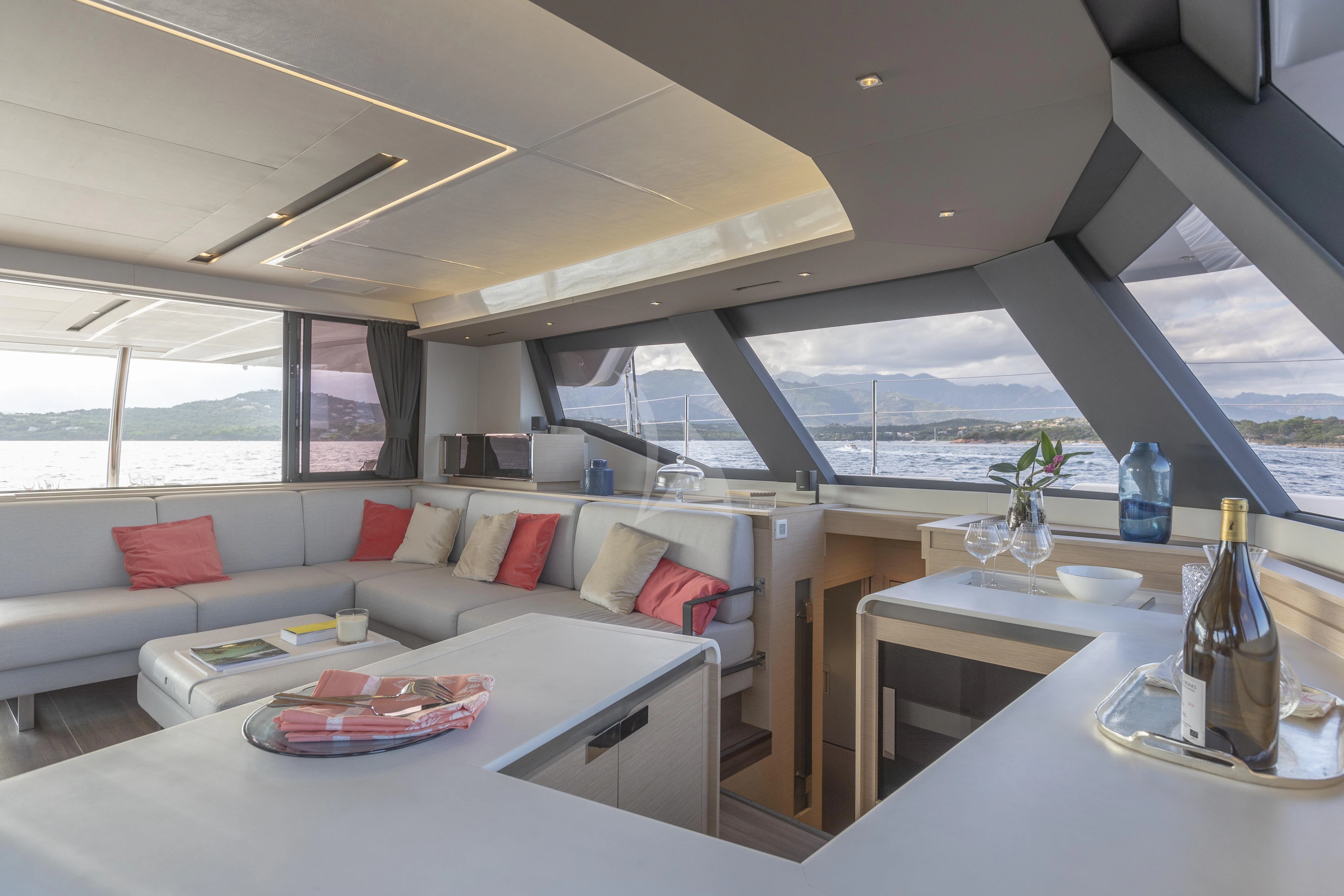 a living room with a large glass window aboard KIMATA Yacht for Charter