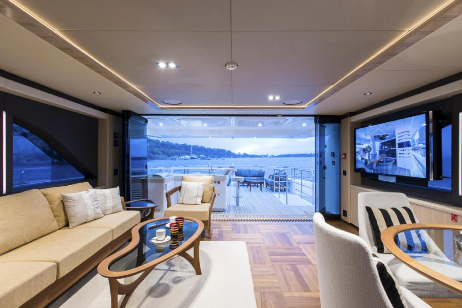 a living room with a large balcony aboard KRISHH Yacht for Sale
