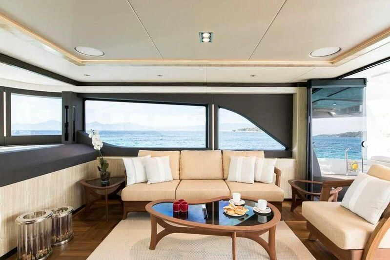 a living room with a large window aboard KRISHH Yacht for Sale