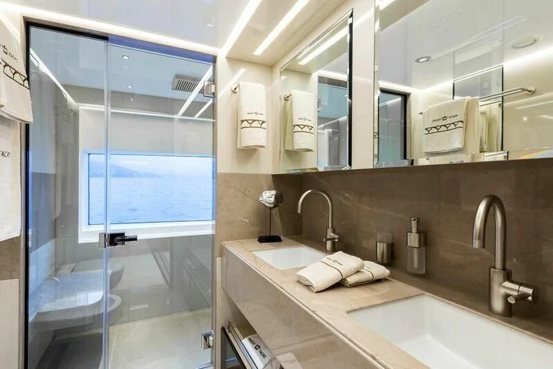 a bathroom with a countertop sink and a large window aboard KRISHH Yacht for Sale