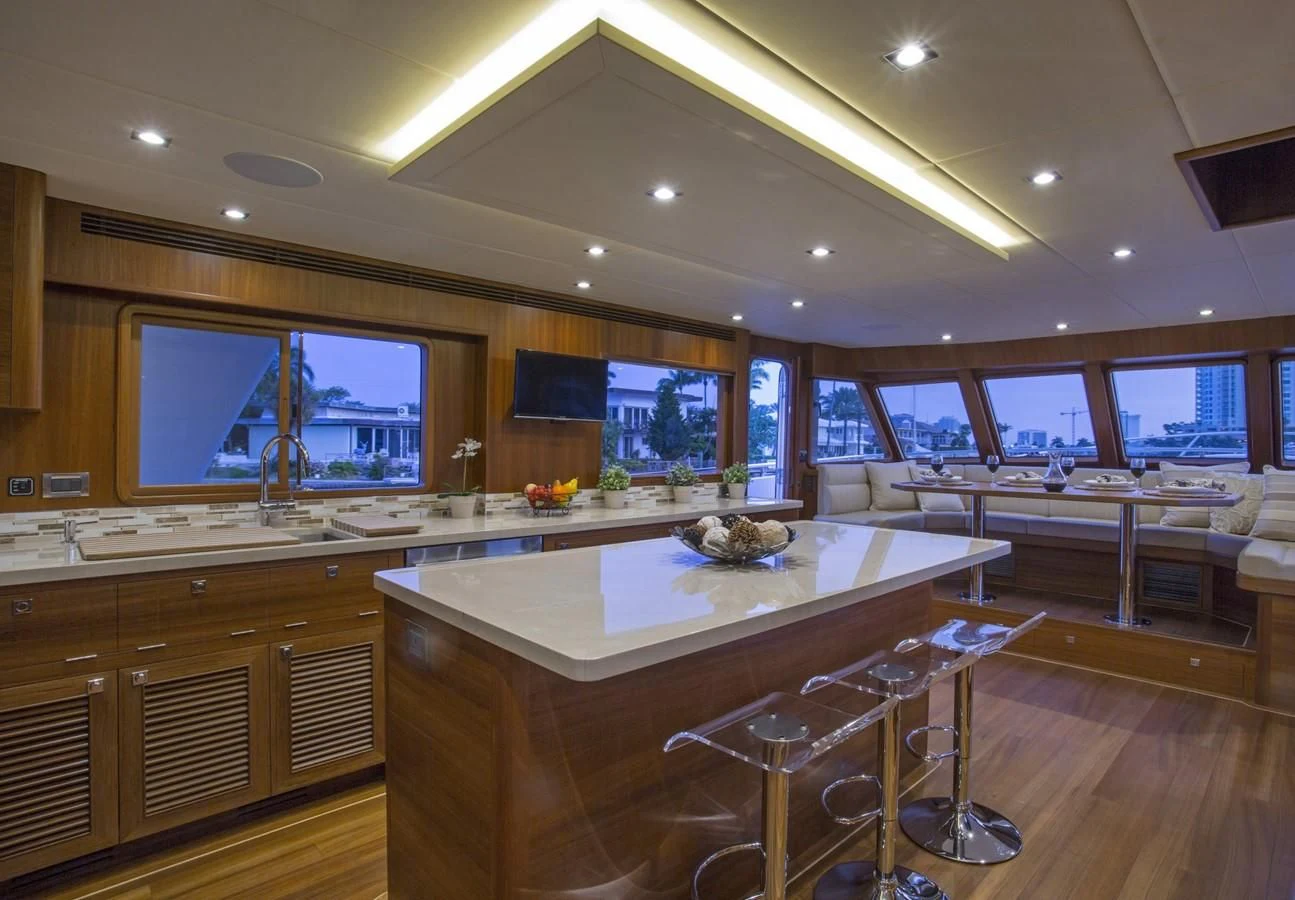 a large kitchen with a bar and bar aboard 860 DBMY Yacht for Sale