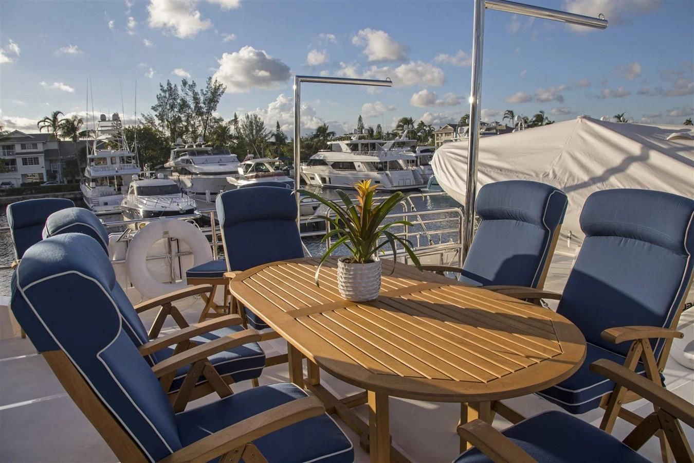 a table and chairs on a deck aboard 860 DBMY Yacht for Sale