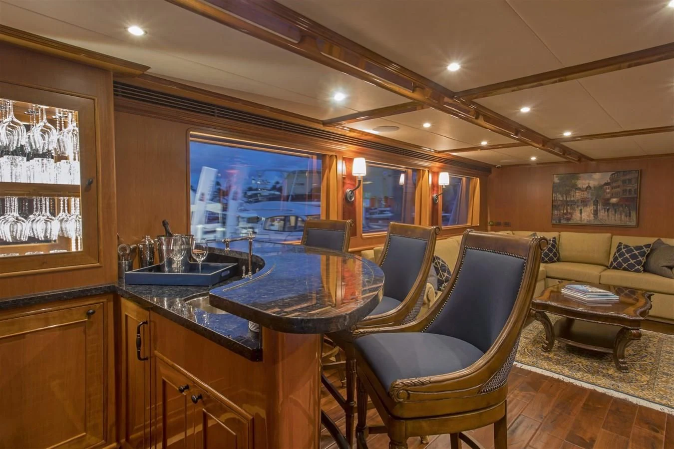 a room with a table chairs and a couch aboard 860 DBMY Yacht for Sale