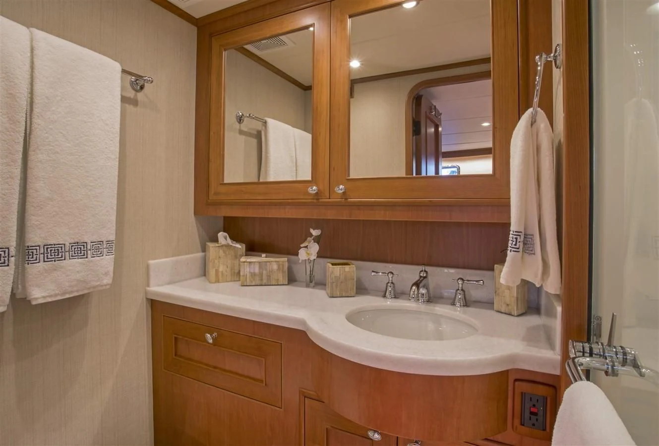 a bathroom with a sink and towels aboard 860 DBMY Yacht for Sale