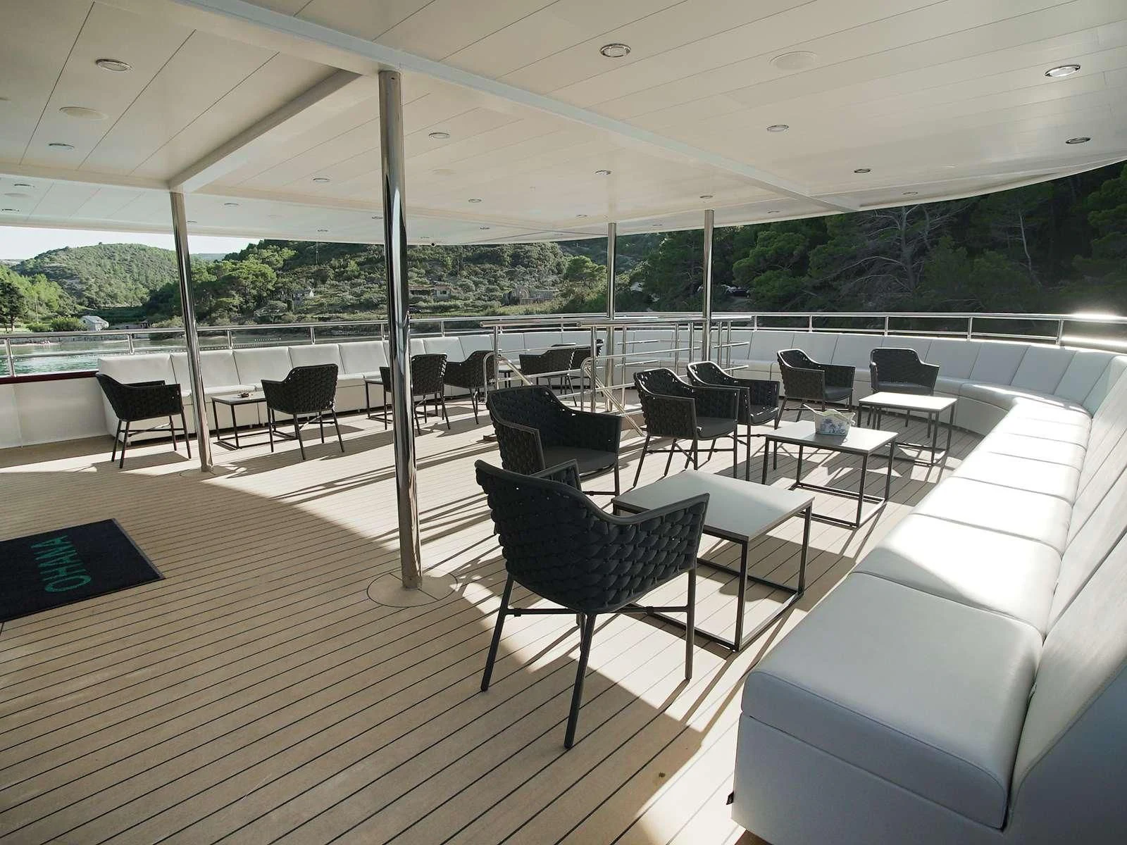 a room with chairs and tables aboard OHANA Yacht for Sale