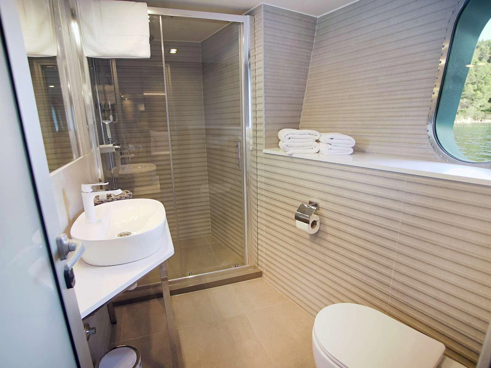 a bathroom with a glass shower aboard OHANA Yacht for Sale