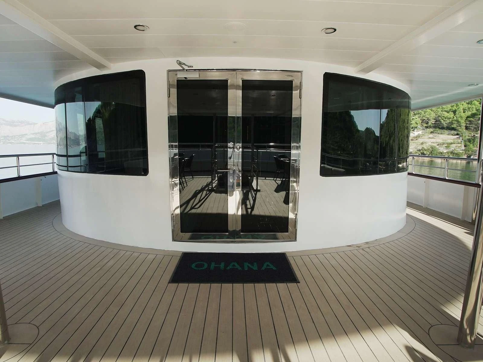 a large white room with a large glass door and a deck aboard OHANA Yacht for Sale
